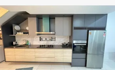 a kitchen with a stainless steel refrigerator and cabinets at Sunrise@Gurney Spacious 2BR Duplex in George Town