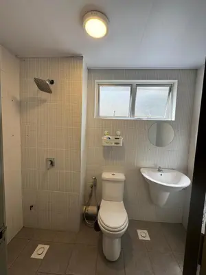a bathroom with a toilet and a sink at The Misty Penthouse in Tanah Rata