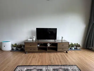 a living room with a flat screen tv on a table at The Misty Penthouse in Tanah Rata