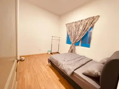 a bedroom with a bed and a window at The Misty Penthouse in Tanah Rata