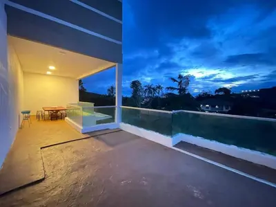 a balcony of a building with a table on it at The Misty Penthouse in Tanah Rata
