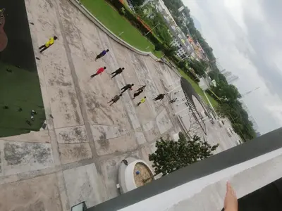a group of people flying kites in a street at Zulcity Homestay in Gelugor