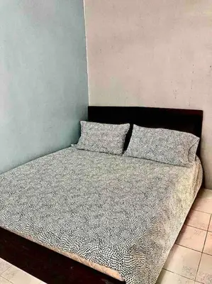 a bed with two pillows on it in a bedroom at SUPER COMFY HOME @ KULIM CITY in Kulim
