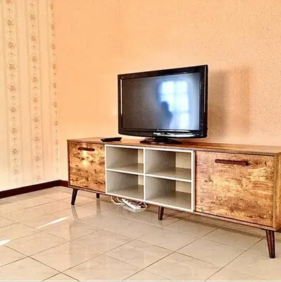 a flat screen tv sitting on top of a wooden entertainment center at SUPER COMFY HOME @ KULIM CITY in Kulim