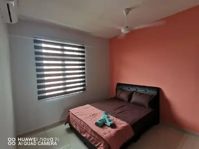 a bedroom with a bed in a room with a window at HK Homestay in Ipoh