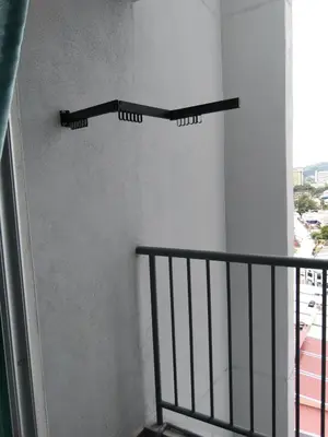 a balcony with a black rail and a window at HK Homestay in Ipoh