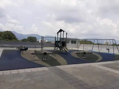 a playground with two swings and a slide at HK Homestay in Ipoh
