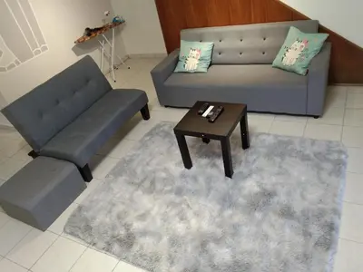 a living room with two couches and a coffee table at QQ Homestay in Ipoh