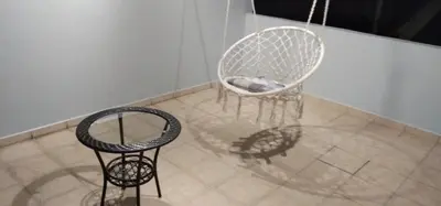 two chairs and a table on a tiled floor at QQ Homestay in Ipoh
