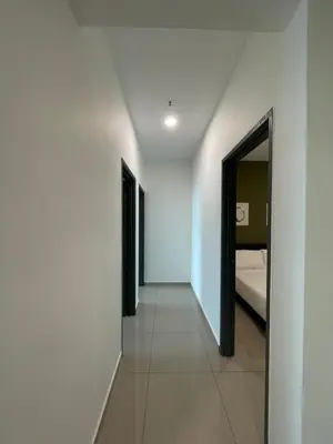 a hallway leading to a bedroom with a bed at METROPOL SERVICED APARTMENT at Bukit Mertajam, Pulau Pinang in Bukit Mertajam