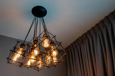 a chandelier hanging from a ceiling with curtains at Ipoh Tambun Lost World Sunway Onsen Suites Lana 2R2B 8 paxs in Tambun