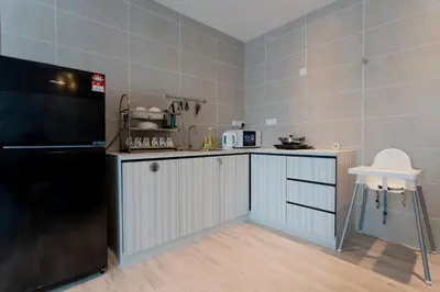 a small kitchen with a counter and a refrigerator at Ipoh Tambun Lost World Sunway Onsen Suites Lana 2R2B 8 paxs in Tambun