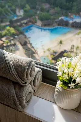 a window with a vase of flowers on a window sill at Ipoh Tambun Lost World Sunway Onsen Suites Lana 2R2B 8 paxs in Tambun