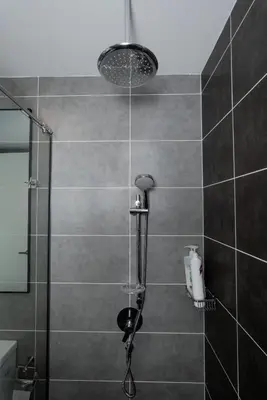 a shower with a glass door in a bathroom at Ipoh Tambun Lost World Sunway Onsen Suites Lana 2R2B 8 paxs in Tambun