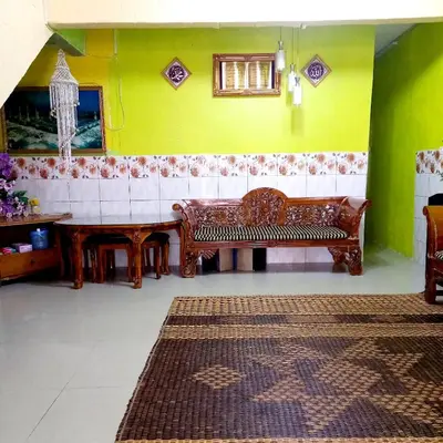 a living room with a bench and a table at Nur's Homestay in Seri Manjung