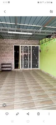 a empty room with a bench and a green wall at Nur's Homestay in Seri Manjung