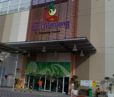 a store with a sign on the side of a building at Nur's Homestay in Seri Manjung