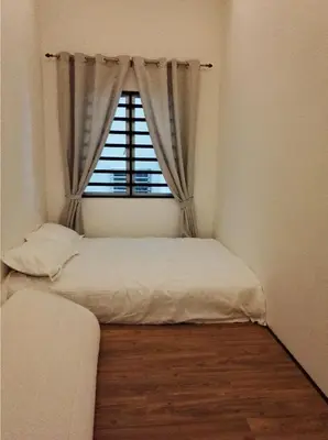 a small room with a bed and a window at Cameron Lovely Home 3 Rooms in Tanah Rata