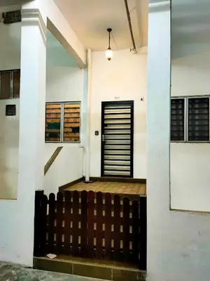 a building with a black door in the middle at Cameron Lovely Home 3 Rooms in Tanah Rata