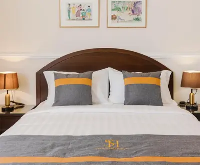 a bedroom with a bed with pillows and two lamps at SPRINGHILL RESORT in Cameron Highlands