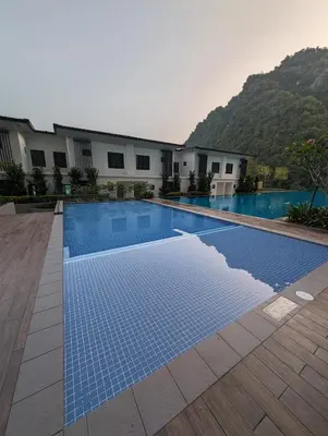a swimming pool in front of a building at Amazing Views & Eco Friendly Luxury Onsen Suites, Lost World of Tambun in Ipoh