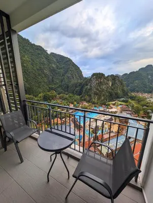 a balcony with chairs and a view of the ocean at Amazing Views & Eco Friendly Luxury Onsen Suites, Lost World of Tambun in Ipoh