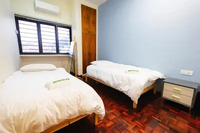 a room with two beds and a window at monstera homestay near Tambun, Ipoh Garden East in Ipoh