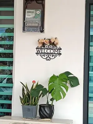 a wall with a telephone and a plant on it at Sweet 3 bedroom home @ Canning Garden, Ipoh in Ipoh