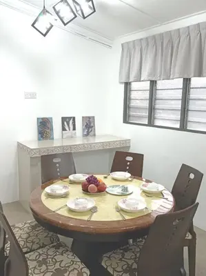 a dining room table with chairs and a table with fruit on it at Sweet 3 bedroom home @ Canning Garden, Ipoh in Ipoh
