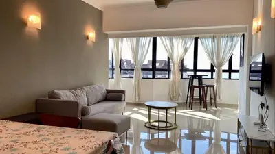 a living room with a couch and a table at The Ferringhi Sea View 777 in Batu Ferringhi
