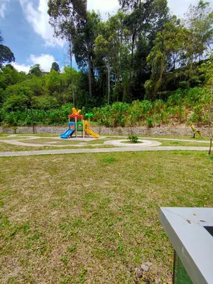 a playground with a slide in a park at Cameron Lovely Cottage 3 Rooms in Tanah Rata