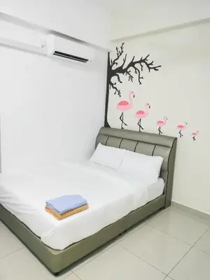 a bedroom with a bed with pink flamingos on the wall at Starlight Homestay The Venus Sitiawan in Seri Manjung