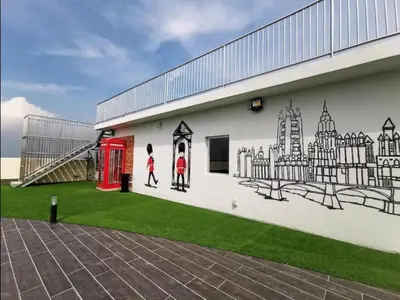 a mural on the side of a building with a red phone booth at Starlight Homestay The Venus Sitiawan in Seri Manjung