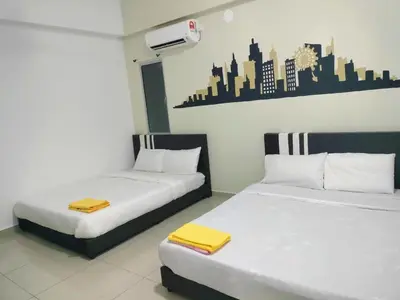 two beds sitting next to each other in a room at Starlight Homestay The Venus Sitiawan in Seri Manjung