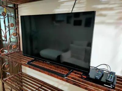 a large flat screen tv sitting on a shelf at 1 MINUTES TO TOWER SENTRAL INTAN HOMESTAY 6 ROOMS in Teluk Intan