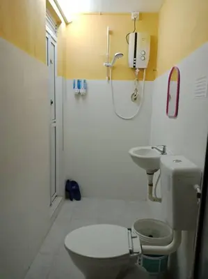 a bathroom with a toilet and a sink at 1 MINUTES TO TOWER SENTRAL INTAN HOMESTAY 6 ROOMS in Teluk Intan