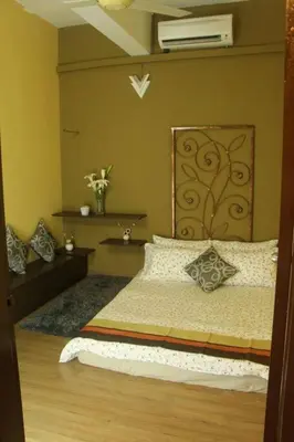 a bedroom with a bed and a fan at 1 MINUTES TO TOWER SENTRAL INTAN HOMESTAY 6 ROOMS in Teluk Intan