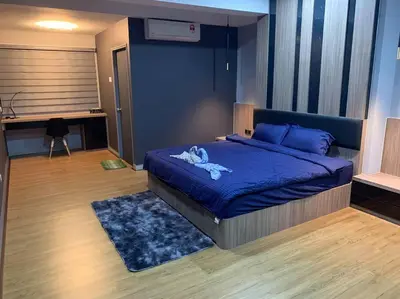a bedroom with a bed with a blue comforter at Ulike homestay~3room~The Venus~Manjung~Lumut in Seri Manjung
