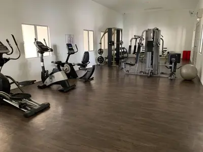 a gym with several treadmills and exercise bikes at Ulike homestay~3room~The Venus~Manjung~Lumut in Seri Manjung