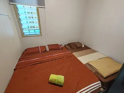 a small bedroom with a bed in a room with a window at ZE II Homestay_Cameron in Tanah Rata