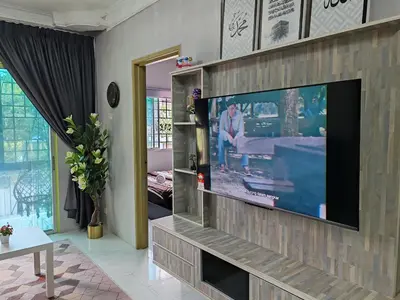 a living room with a flat screen tv on a wall at ZE II Homestay_Cameron in Tanah Rata