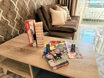 a coffee table with books and magazines on it at IPOH CITY CENTRE Majestic Homestay Pool View 3 mins Walking to Famous Food Places & 15mins to Old Town Ipoh by Happy Homestay in Ipoh