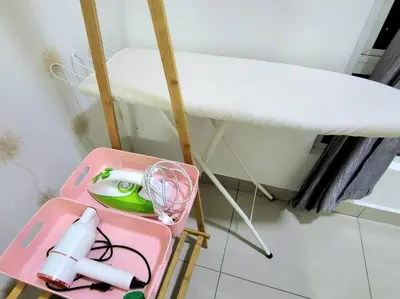 a pink suitcase sitting on a floor next to a surfboard at IPOH CITY CENTRE Majestic Homestay Pool View 3 mins Walking to Famous Food Places & 15mins to Old Town Ipoh by Happy Homestay in Ipoh