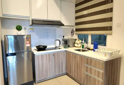a kitchen with a stainless steel refrigerator and cabinets at IPOH CITY CENTRE Majestic Homestay Pool View 3 mins Walking to Famous Food Places & 15mins to Old Town Ipoh by Happy Homestay in Ipoh