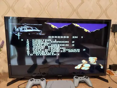 a television with two video game controllers in front of it at IPOH CITY CENTRE Majestic Homestay Pool View 3 mins Walking to Famous Food Places & 15mins to Old Town Ipoh by Happy Homestay in Ipoh