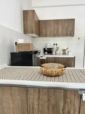 a kitchen counter with a basket on a counter top at Lily Ville in Tanah Rata