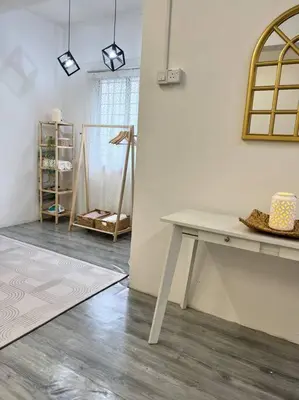a room with a white table and a shelf at Roemah lily studio in Tanah Rata