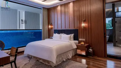 a bedroom with a large bed and a large window at Bertam Resort & Water Park Penang in Kepala Batas