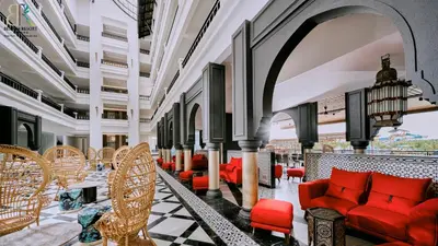 a lobby with red chairs and tables at Bertam Resort & Water Park Penang in Kepala Batas