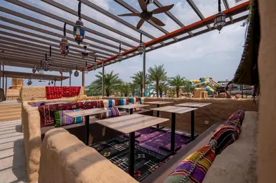 a patio with tables and couches and a water park at Bertam Resort & Water Park Penang in Kepala Batas